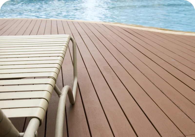 Lounge chair on wooden deck by water